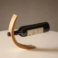 Gravity Bottle Stand balancing a full wine bottle by Everstock Goods